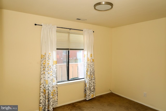 empty room with carpet flooring and baseboards