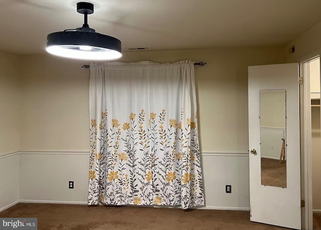 carpeted empty room with baseboards