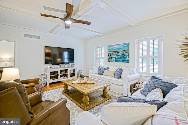 living room with visible vents, ceiling fan, wood finished floors, and beamed ceiling