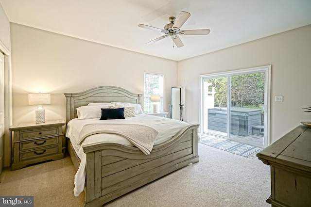 bedroom featuring access to outside, a ceiling fan, and light colored carpet
