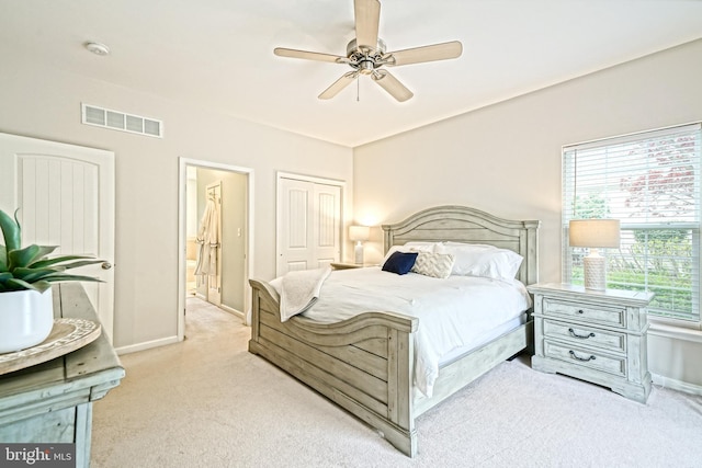 carpeted bedroom with visible vents, a ceiling fan, baseboards, and a closet