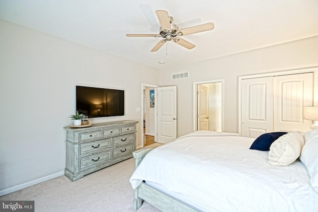 bedroom featuring light colored carpet, a ceiling fan, baseboards, visible vents, and a closet