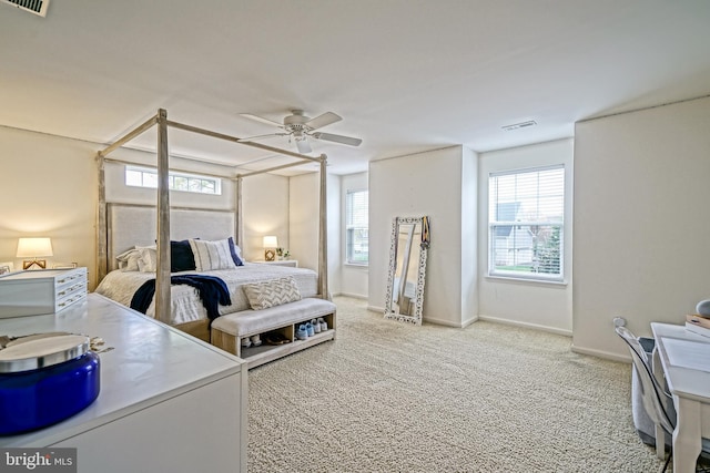 carpeted bedroom featuring visible vents, baseboards, and ceiling fan