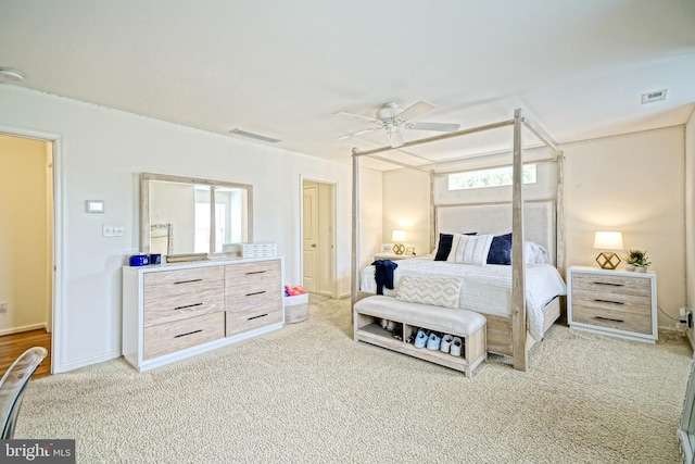 carpeted bedroom featuring a ceiling fan, visible vents, and multiple windows