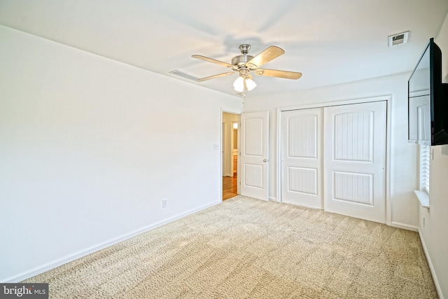 unfurnished bedroom featuring a closet, baseboards, carpet flooring, and visible vents