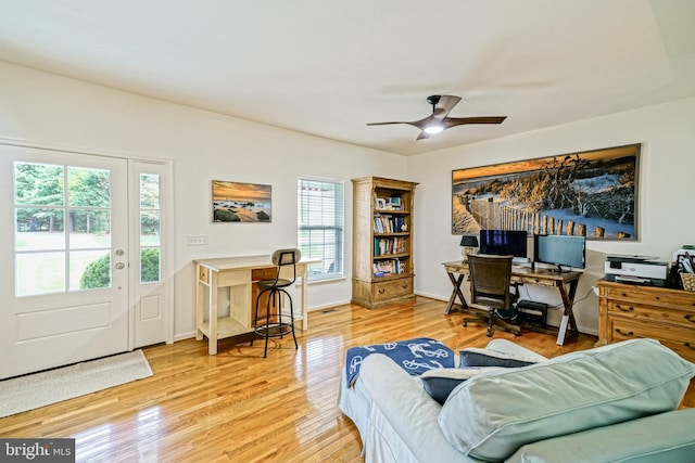 office area with a ceiling fan and wood finished floors