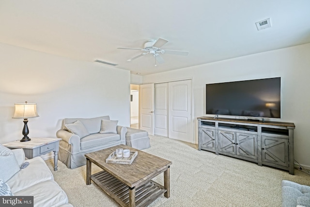 carpeted living area featuring visible vents, a ceiling fan, and baseboards