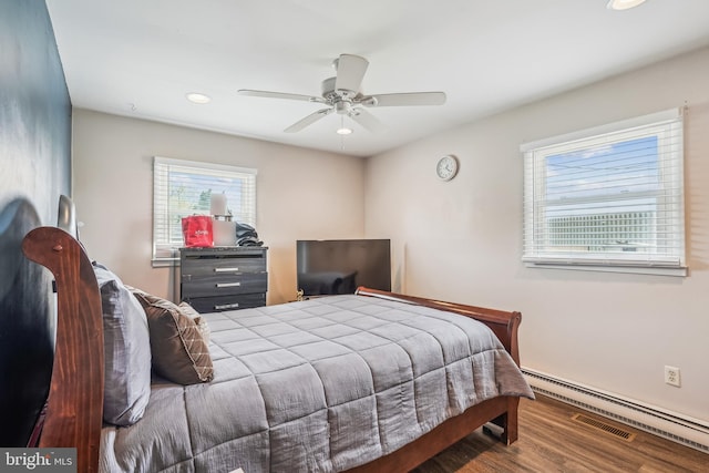 bedroom featuring a baseboard heating unit, recessed lighting, a ceiling fan, visible vents, and wood finished floors