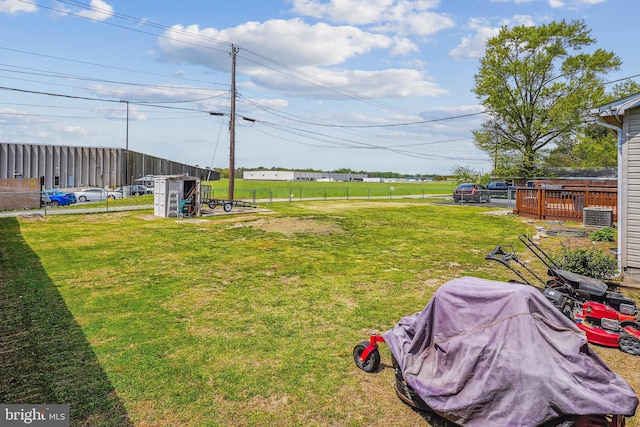 view of yard with fence and central AC