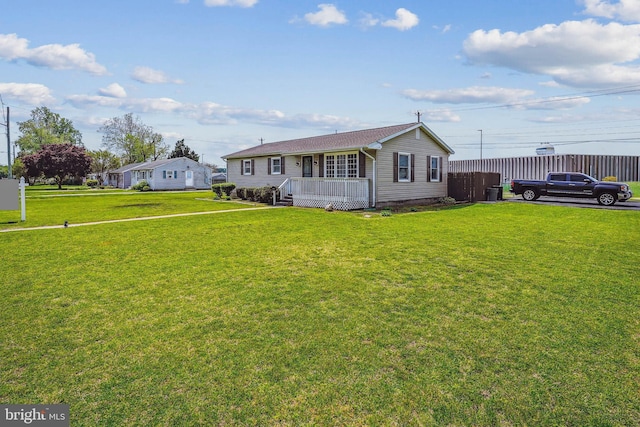 view of front facade featuring a front lawn, a deck, crawl space, and fence