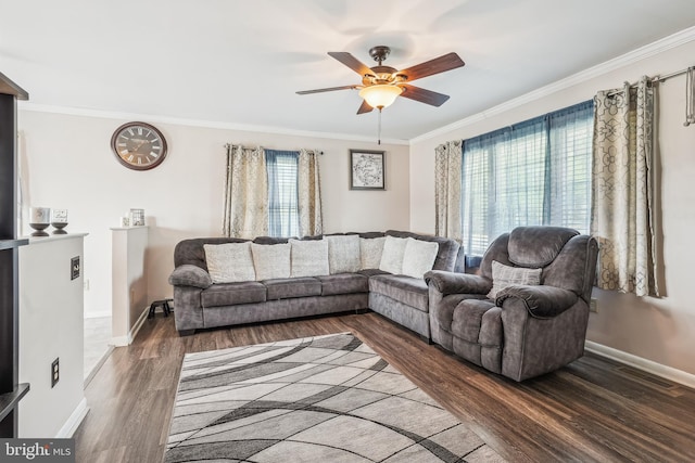 living area featuring wood finished floors, ceiling fan, ornamental molding, and baseboards