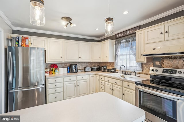 kitchen with appliances with stainless steel finishes, light countertops, crown molding, and a sink