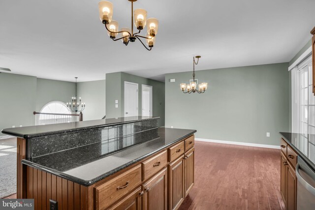 5 Raven Way, Shippensburg, PA 17257 - kitchen featuring brown cabinetry, stainless steel dishwasher, a notable chandelier, and a healthy amount of sunlight