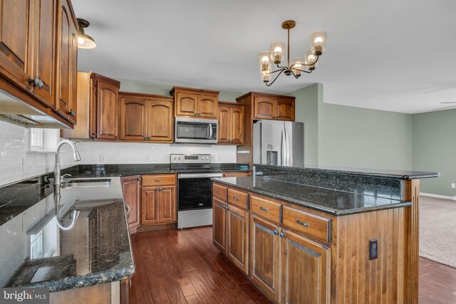 5 Raven Way, Shippensburg, PA 17257 - kitchen with dark wood-style floors, a sink, a notable chandelier, brown cabinets, and appliances with stainless steel finishes