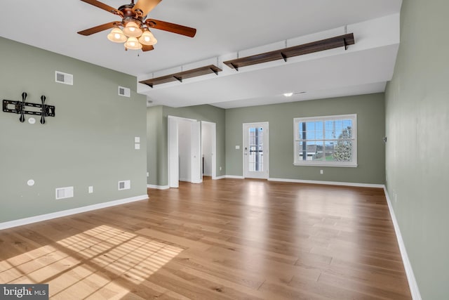 5 Raven Way, Shippensburg, PA 17257 - unfurnished living room with a ceiling fan, wood finished floors, and visible vents