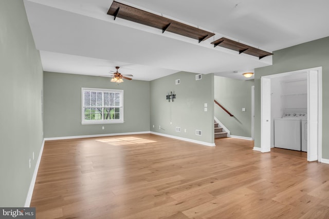 5 Raven Way, Shippensburg, PA 17257 - unfurnished living room with light wood-style floors, baseboards, separate washer and dryer, stairs, and ceiling fan