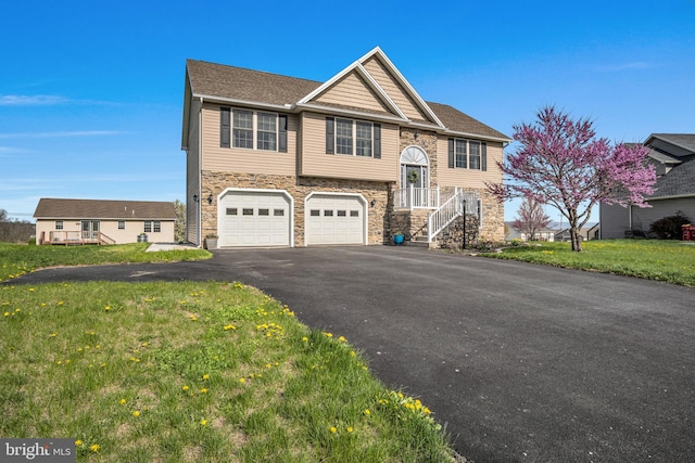 5 Raven Way, Shippensburg, PA 17257 - split foyer home with a front lawn, driveway, stone siding, roof with shingles, and a garage