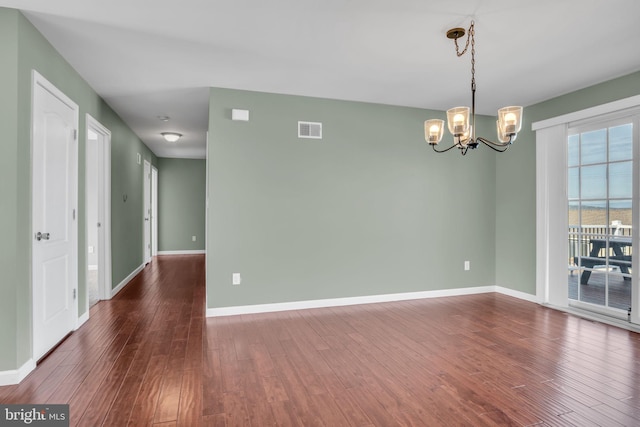 5 Raven Way, Shippensburg, PA 17257 - spare room featuring a chandelier, dark wood finished floors, visible vents, and baseboards