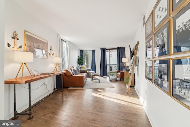 interior space with baseboards, visible vents, and wood finished floors