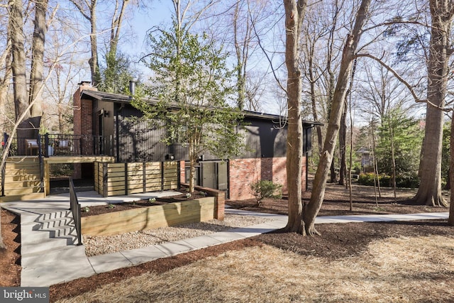 view of yard with a wooden deck and stairway