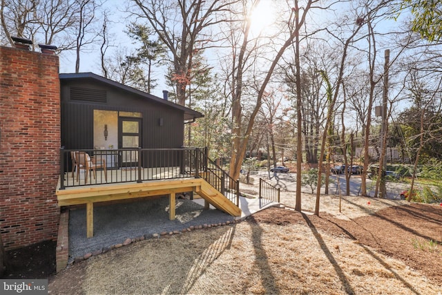 view of yard with stairs and a deck