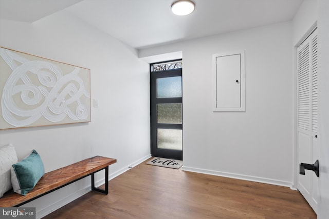 entrance foyer featuring baseboards and wood finished floors
