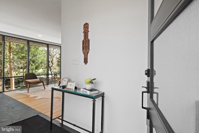 corridor featuring expansive windows and recessed lighting