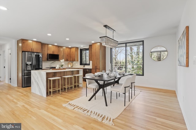 dining area featuring recessed lighting, light wood-style floors, and baseboards