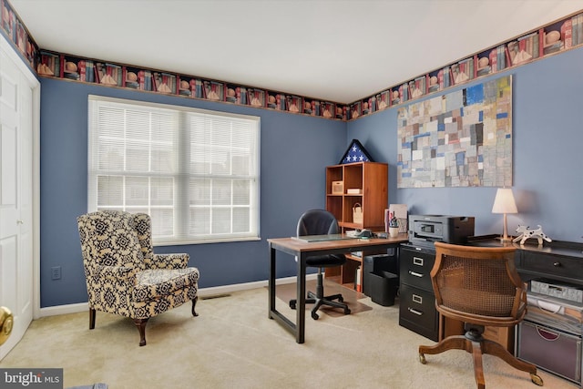 carpeted home office featuring baseboards