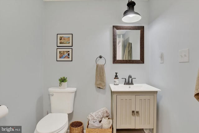 bathroom featuring toilet and vanity