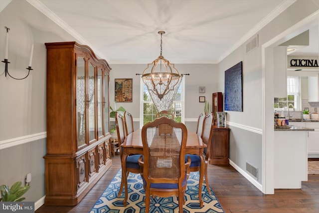dining room featuring a wealth of natural light, visible vents, an inviting chandelier, and dark wood-style flooring