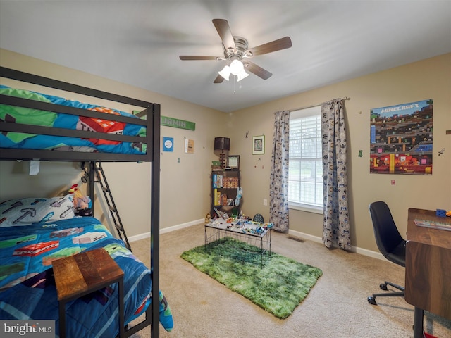 carpeted bedroom with ceiling fan and baseboards