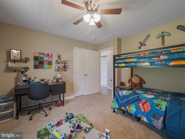 bedroom featuring attic access, a ceiling fan, and carpet flooring