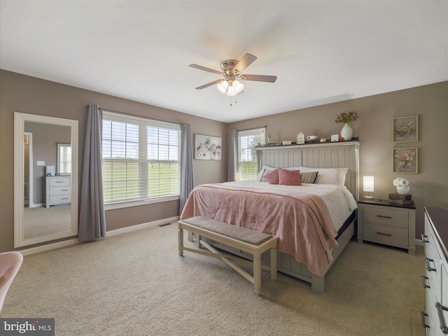 bedroom with baseboards, light colored carpet, and ceiling fan