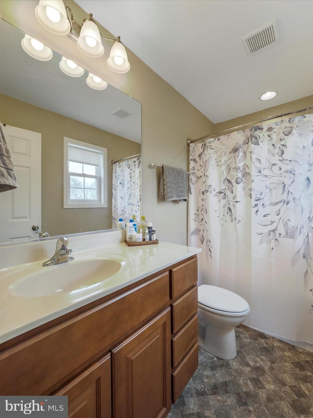 full bathroom featuring stone finish flooring, visible vents, toilet, and vanity