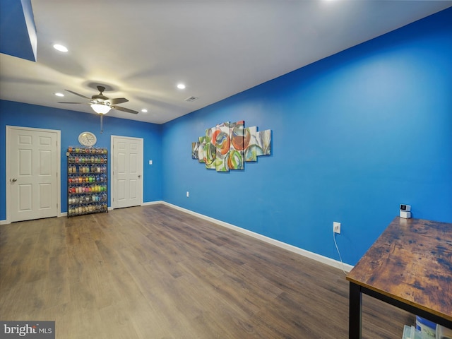 interior space with ceiling fan, baseboards, wood finished floors, and recessed lighting