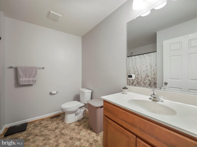 full bath with visible vents, toilet, baseboards, and vanity