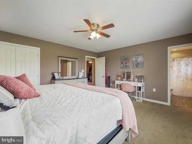 bedroom featuring light carpet, connected bathroom, a closet, baseboards, and ceiling fan