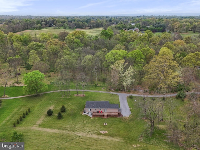 drone / aerial view featuring a forest view