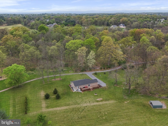 drone / aerial view featuring a wooded view