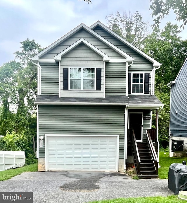 7721 Woodlawn Ave, Pasadena, MD 21122 - view of front facade featuring an attached garage and asphalt driveway