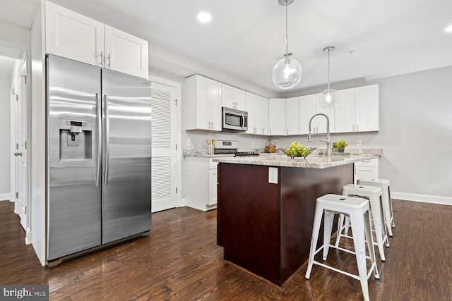 kitchen with white cabinets, appliances with stainless steel finishes, dark wood finished floors, recessed lighting, and baseboards