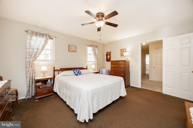 bedroom featuring ceiling fan, baseboards, and dark colored carpet