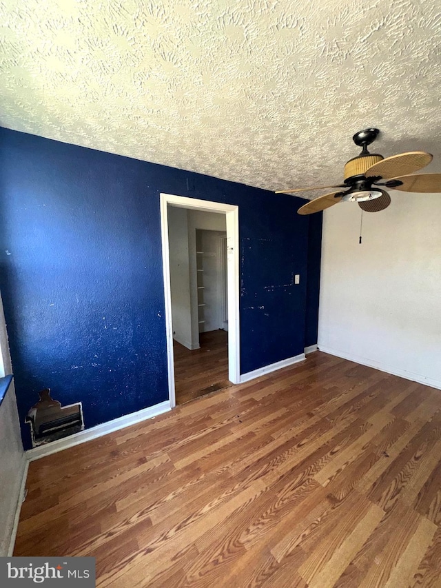 7437 Berkshire Rd, Baltimore, MD 21224 - spare room featuring a textured ceiling, a ceiling fan, wood finished floors, and baseboards