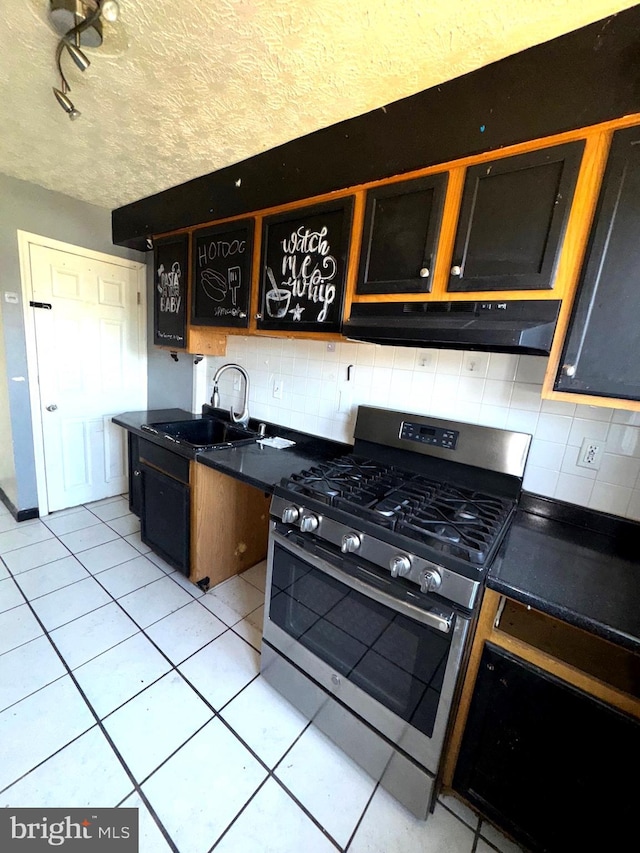 7437 Berkshire Rd, Baltimore, MD 21224 - kitchen featuring stainless steel gas range, under cabinet range hood, tasteful backsplash, and dark countertops
