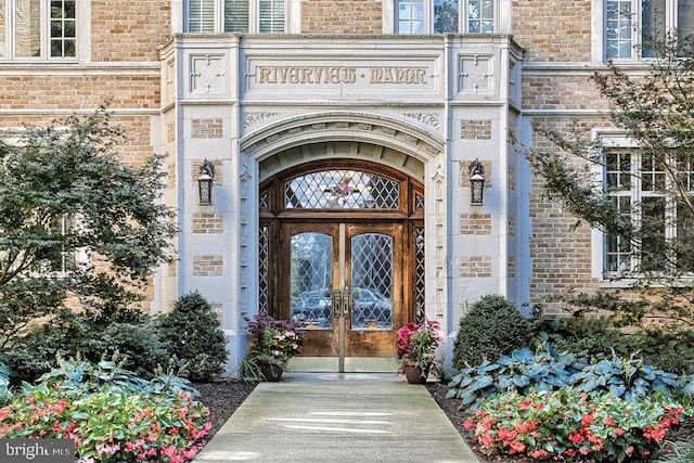 doorway to property featuring stone siding and french doors