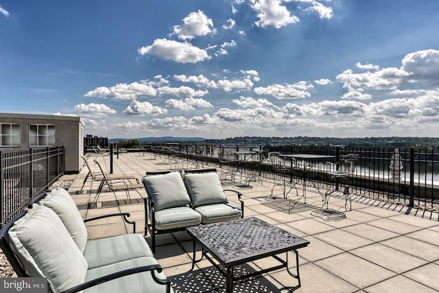 view of patio / terrace with an outdoor living space and fence