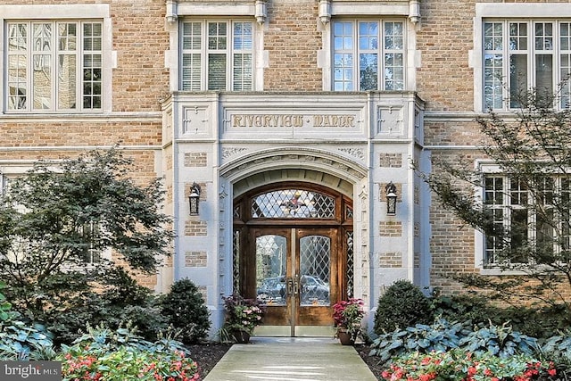doorway to property featuring french doors and stone siding
