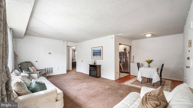 3801 Swann Rd Unit 101, Suitland, MD 20746 - living area with a textured ceiling and carpet floors