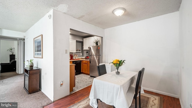 3801 Swann Rd Unit 101, Suitland, MD 20746 - dining space with a textured ceiling and light wood finished floors